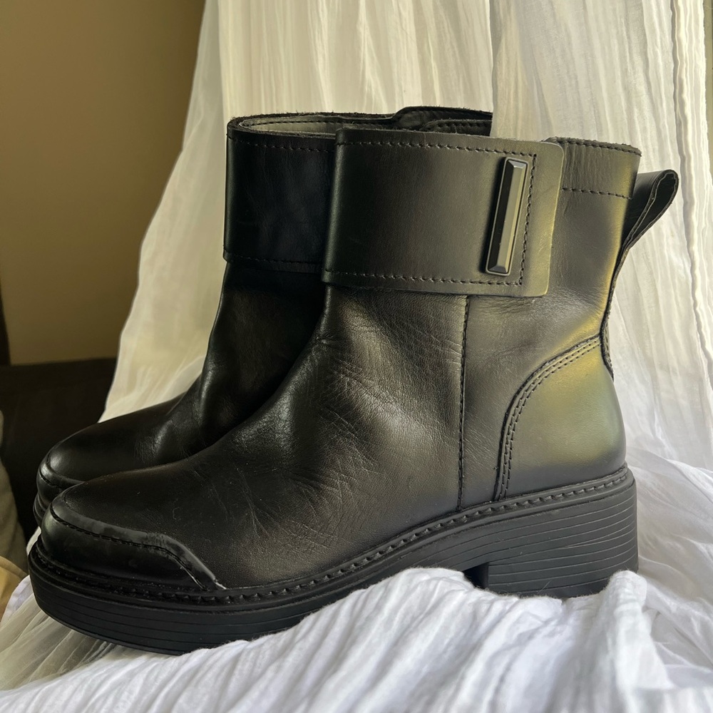 Black leather ankle boots with side zip and Velcro buckle closure. Franco Sarto